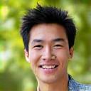 Portrait of Alex Chen, a software developer, smiling in an outdoor setting