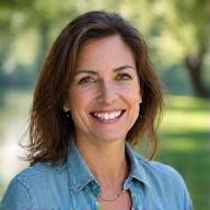 Portrait of Dr. Anya Sharma, a warm and empathetic licensed therapist, engaged in conversation on a quiet trail