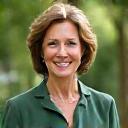 Sarah M., a business executive, looking refreshed and confident in a green outdoor setting